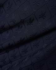 Mens Garry Jacquard Johnny Collar Polo in dark navy, featuring an all-over tone-on-tone jacquard knit pattern of the iconic Psycho Bunny skull logo within hexagonal shapes. (7)