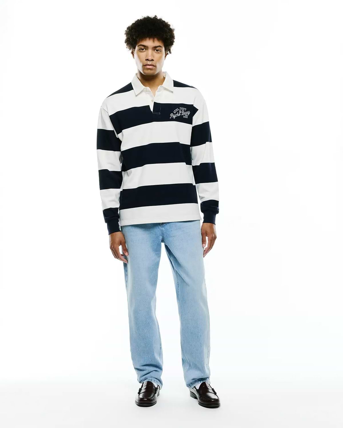Mens Keven Ls Relaxed Fit Polo, a navy and white striped jersey knit with a white collar and an embroidered ATHL. DEPT Psycho Bunny EST. 2005 logo on the left chest. (6)