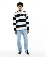 Mens Keven Ls Relaxed Fit Polo, a navy and white striped jersey knit with a white collar and an embroidered ATHL. DEPT Psycho Bunny EST. 2005 logo on the left chest. (6)