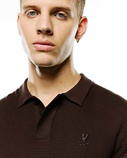 Men's Leroy Longsleeve Knit Polo, dark brown textured knit with a classic collar, two-button placket, and small embroidered Psycho Bunny skull logo on the left chest. (2)