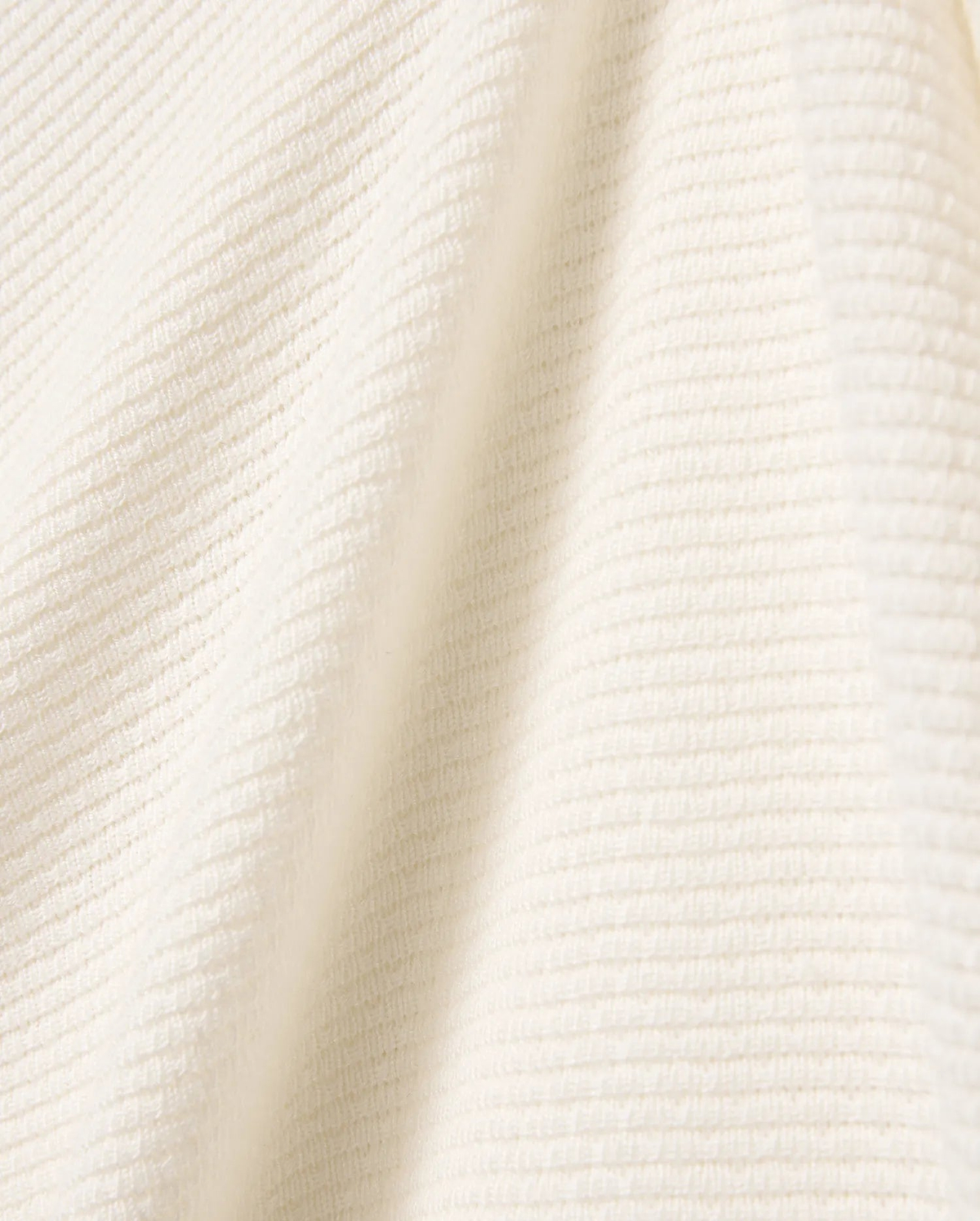 Mens Leroy Long Sleeve Knit Polo in a luxurious cream hue, showcasing a refined, soft-touch ribbed knit texture, embodying Psycho Bunny's premium streetwear aesthetic.