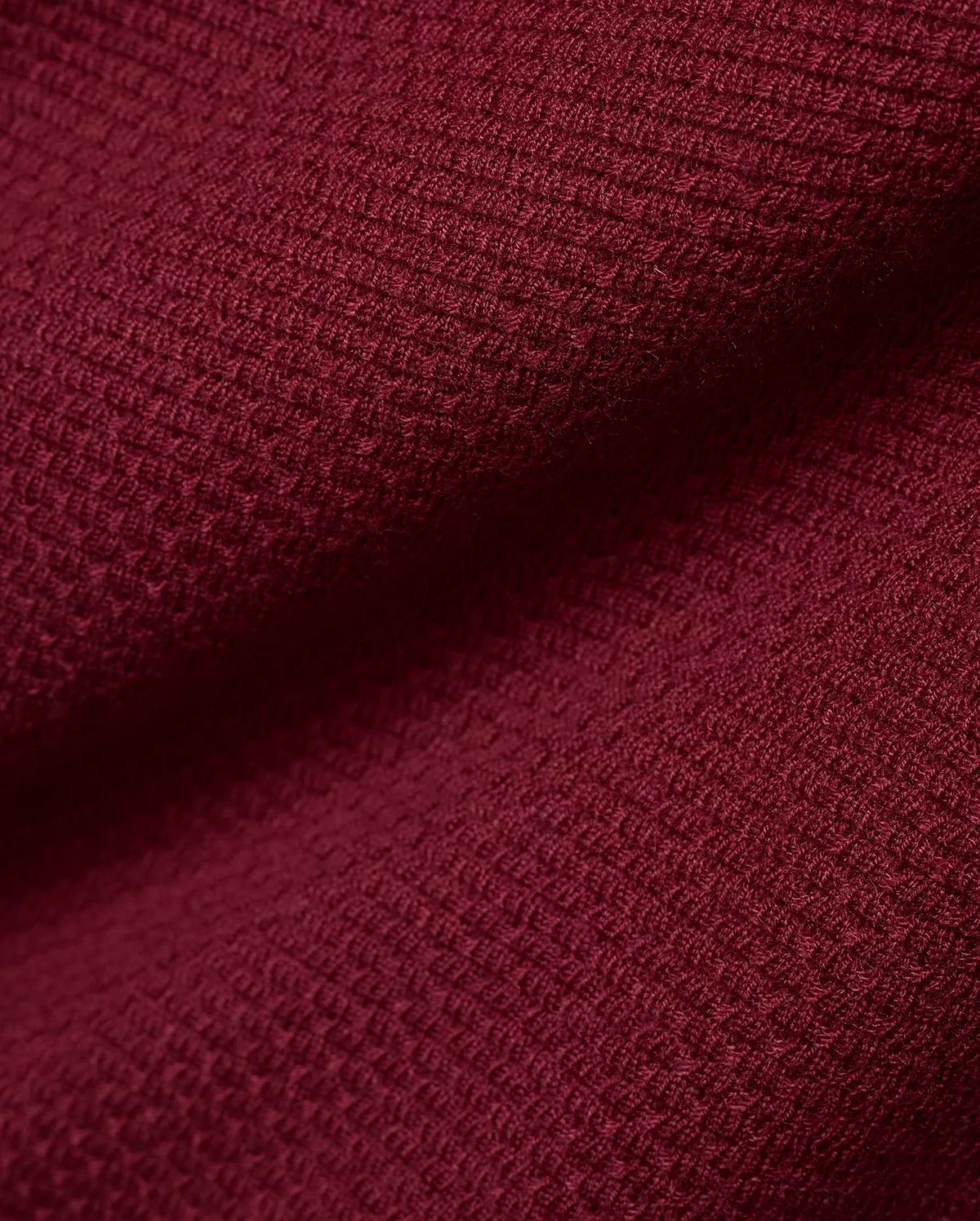 Men's Leroy Longsleeve Knit Polo in a luxurious, deep burgundy hue, showcasing its refined, premium textured waffle knit fabric with subtle variations in light and shadow. (6)