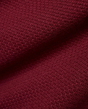 Men's Leroy Longsleeve Knit Polo in a luxurious, deep burgundy hue, showcasing its refined, premium textured waffle knit fabric with subtle variations in light and shadow. (6)