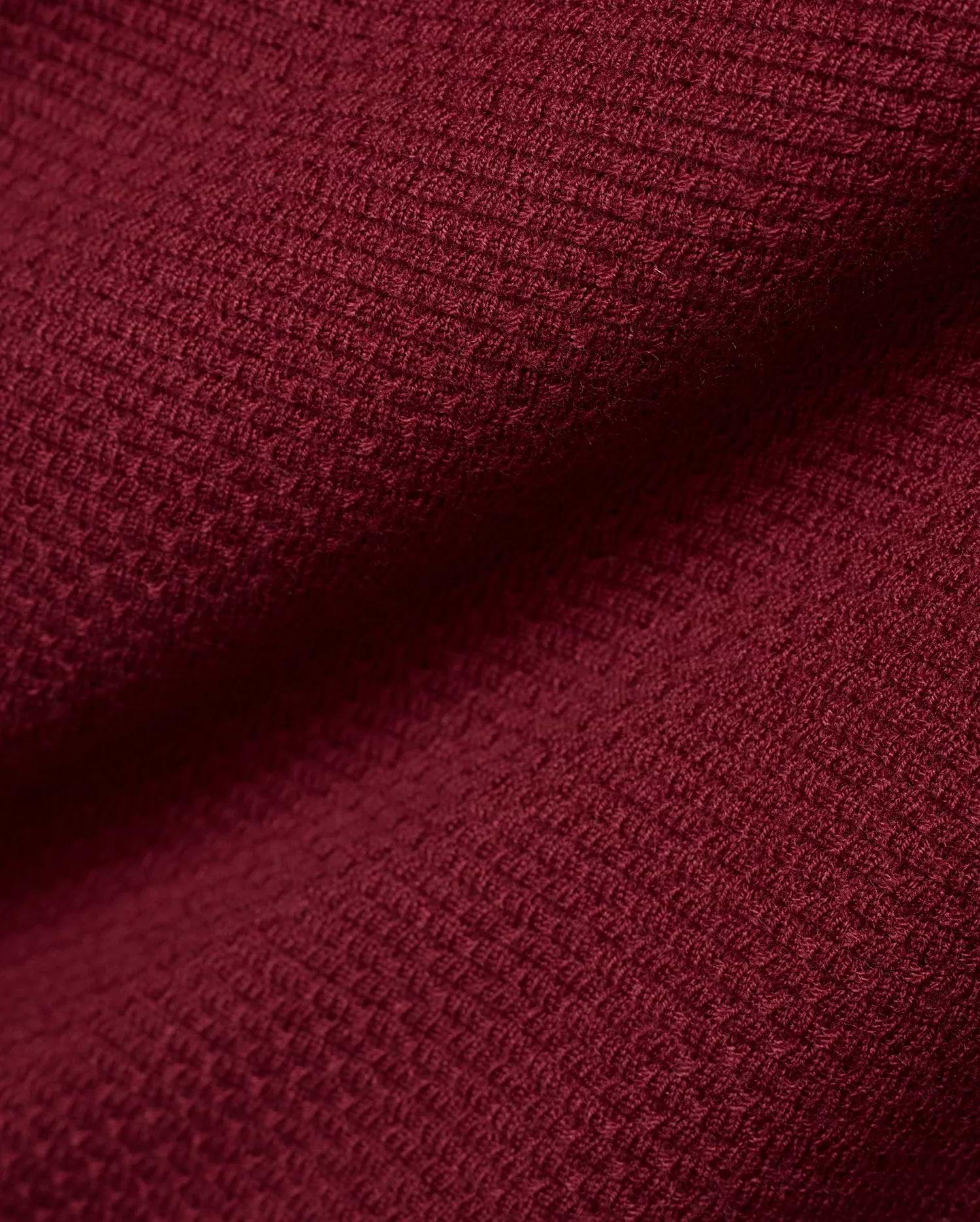Men's Leroy Longsleeve Knit Polo in a luxurious, deep burgundy hue, showcasing its refined, premium textured waffle knit fabric with subtle variations in light and shadow. (6)