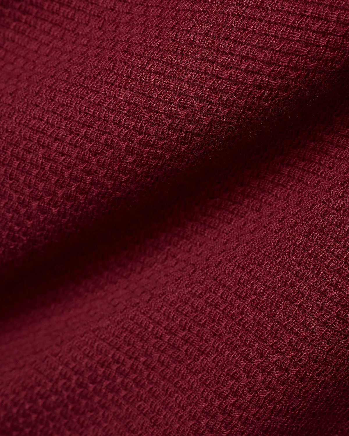 Men's Leroy Longsleeve Knit Polo in a luxurious, deep burgundy hue, showcasing its refined, premium textured waffle knit fabric with subtle variations in light and shadow. (6)