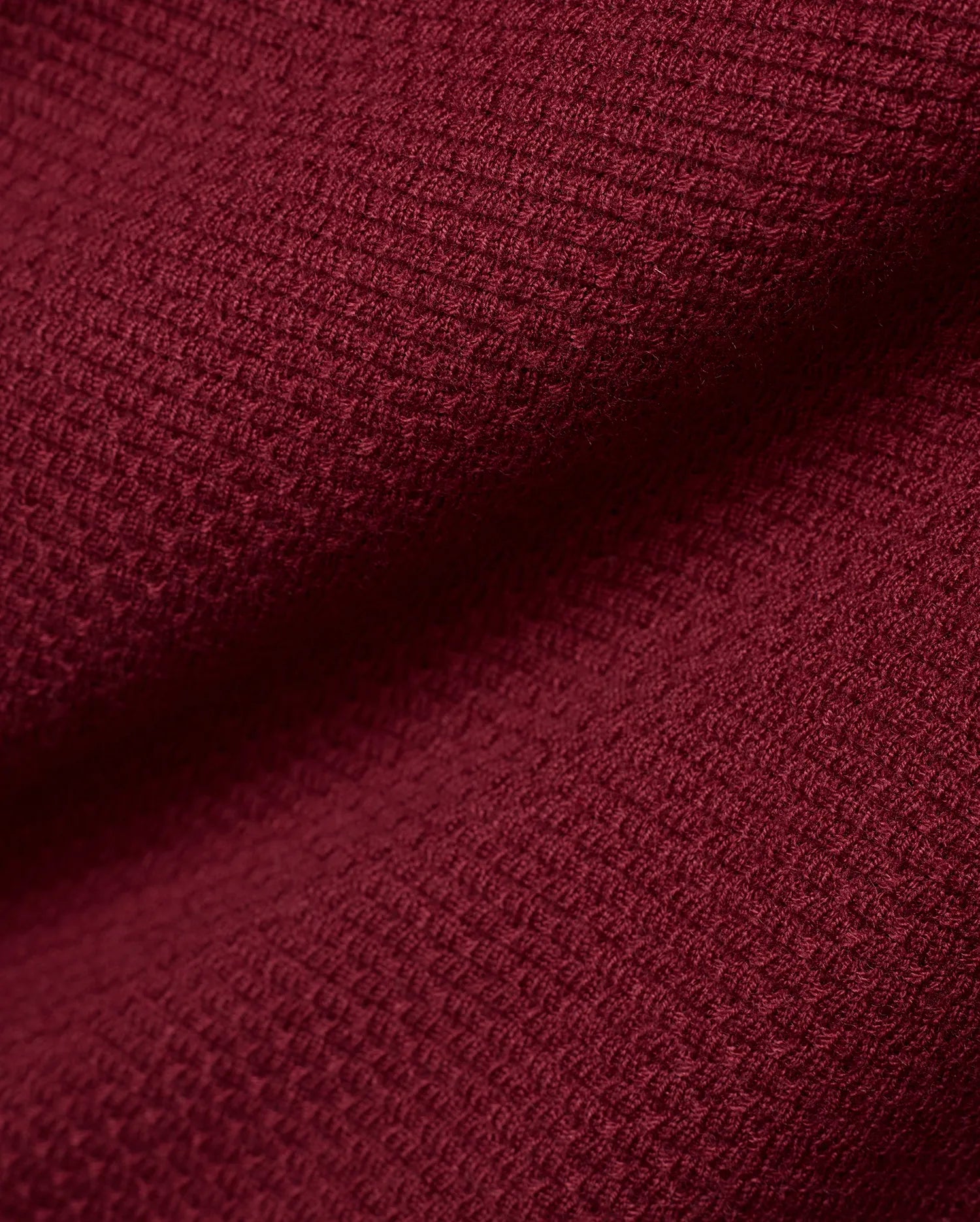 Men's Leroy Longsleeve Knit Polo in a luxurious, deep burgundy hue, showcasing its refined, premium textured waffle knit fabric with subtle variations in light and shadow. (6)