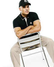 Mens Robin Pima Piqué Polo in dark green, with white-tipped collar, light placket, and white-striped cuffs. Embroidered Psycho Bunny skull logo on left chest. Black cap and khaki pants.