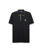 Mens Robin Pique Polo, black classic fit with cream piping on the collar and cuffs, featuring a textured pique fabric and an embroidered Psycho Bunny skull logo on the left chest.