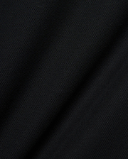 Mens Robin Pique Polo, a premium black pique knit fabric showcasing its distinctive textured weave and subtle drape, embodying Psycho Bunny's refined streetwear quality.