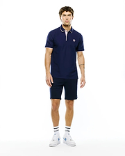 MENS ROBIN PIQUE POLO in navy, classic fit, with white collar tipping, pink placket and cuff trim, and a small embroidered Psycho Bunny skull logo on the left chest.