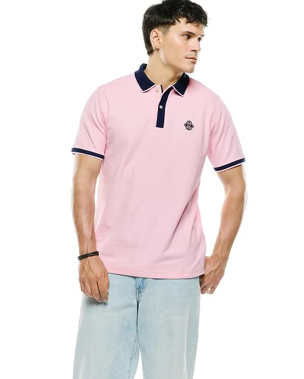 Mens Robin Pique Polo in classic fit pink pique with navy blue collar, placket, and sleeve cuffs, featuring a small embroidered Psycho Bunny skull logo on the left chest.