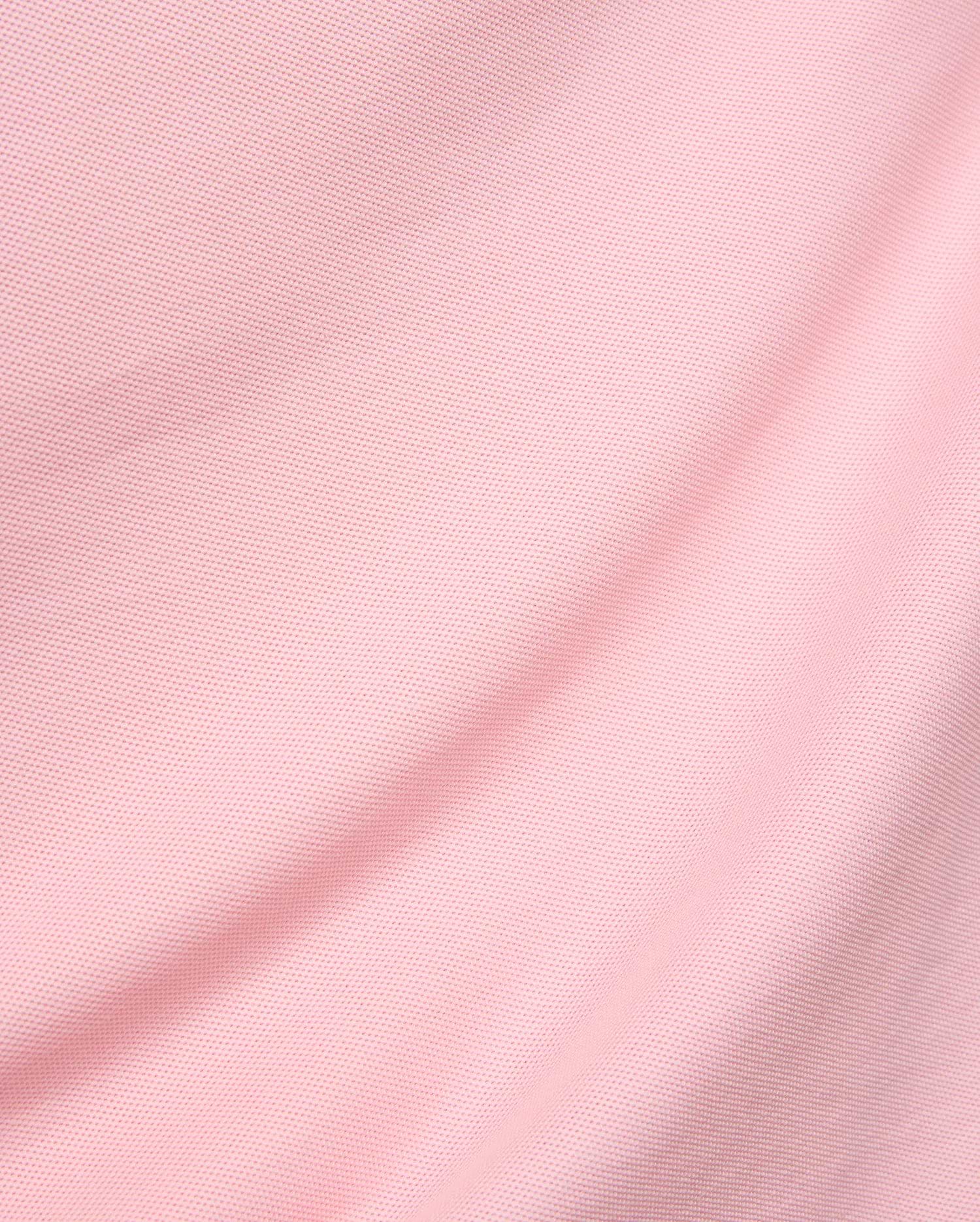 Mens Robin Pique Polo in a vibrant blush pink, showcasing its premium, classic textured pique knit fabric with elegant, soft folds, reflecting Psycho Bunny's refined streetwear aesthetic.