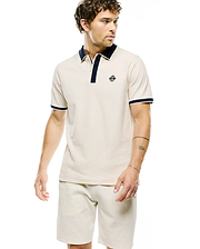Mens Robin Pique Polo, cream classic fit pique polo with navy collar, placket, and sleeve cuffs featuring a small embroidered Psycho Bunny skull logo on the left chest.