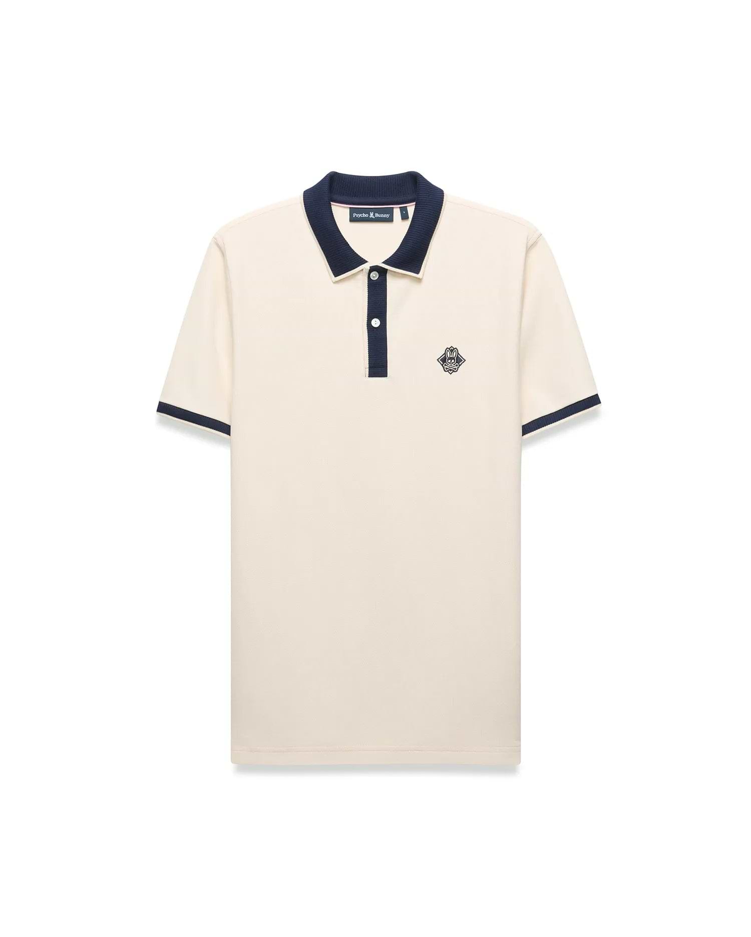 Mens Robin Pique Polo, a classic fit cream pique polo with navy blue ribbed collar, two-button placket, cuffs, and an embroidered Psycho Bunny skull logo on the left chest.