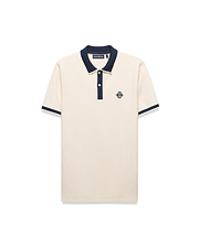 Mens Robin Pique Polo, a classic fit cream pique polo with navy blue ribbed collar, two-button placket, cuffs, and an embroidered Psycho Bunny skull logo on the left chest.