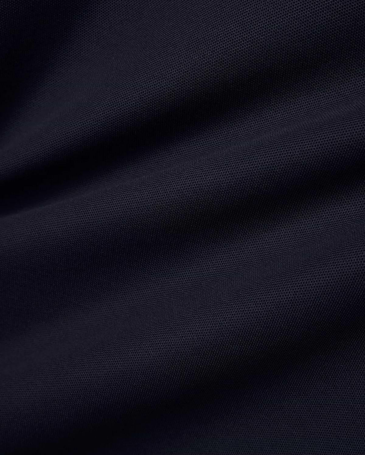 Men's Grover Pique Longsleeve Polo in a deep, luxurious navy blue, showcasing the premium, breathable pique fabric texture with subtle, elegant drapes, perfect for refined streetwear. (6)