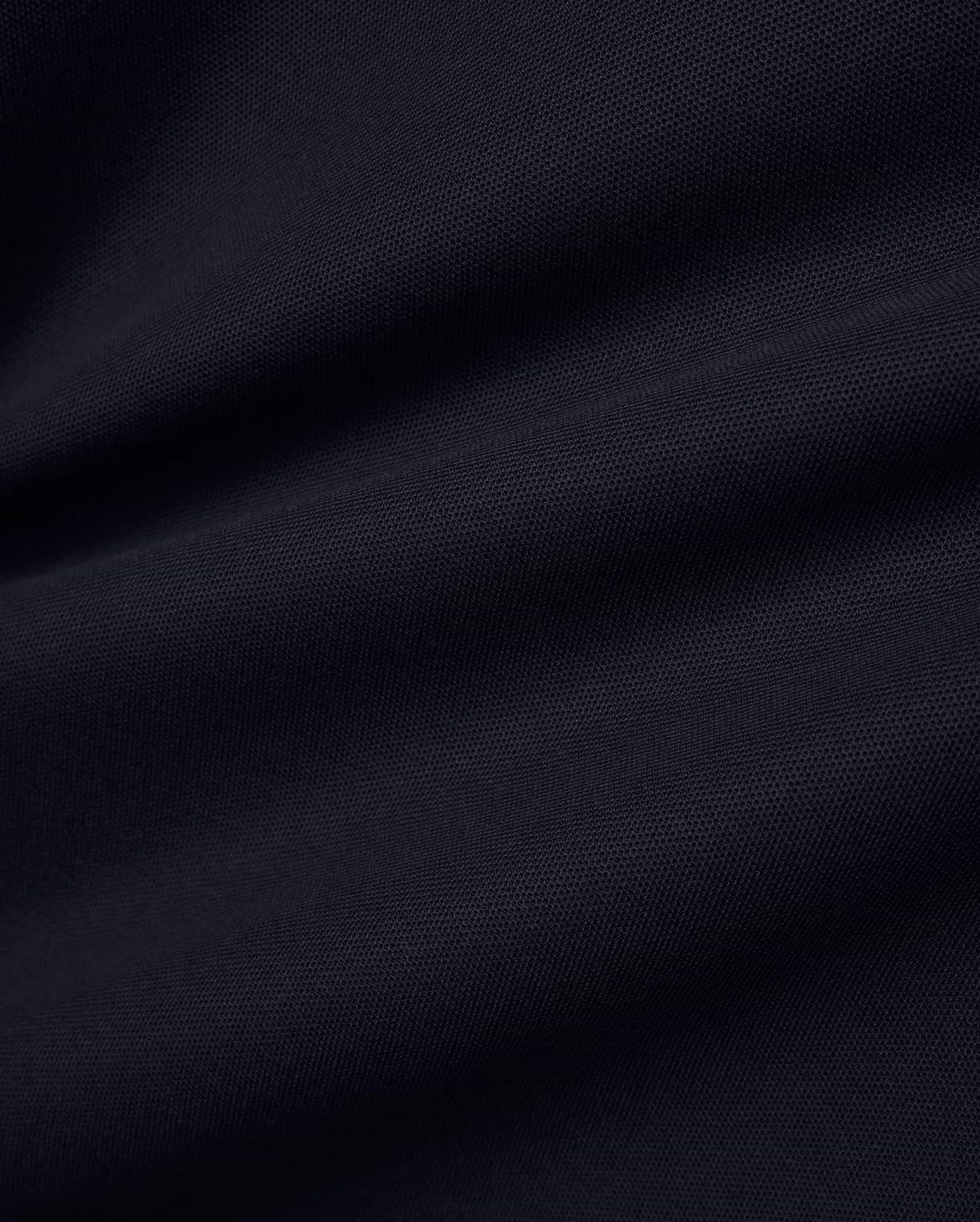Men's Grover Pique Longsleeve Polo in a deep, luxurious navy blue, showcasing the premium, breathable pique fabric texture with subtle, elegant drapes, perfect for refined streetwear. (6)