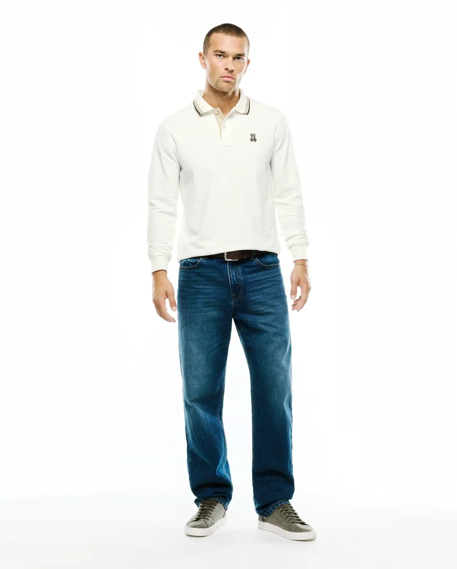 Men's Grover Pique Longsleeve Polo in off-white, classic fit, featuring a textured pique fabric, two-button placket, tipped collar with a dark stripe, and a small embroidered Psycho Bunny skull logo on the left chest. (4)
