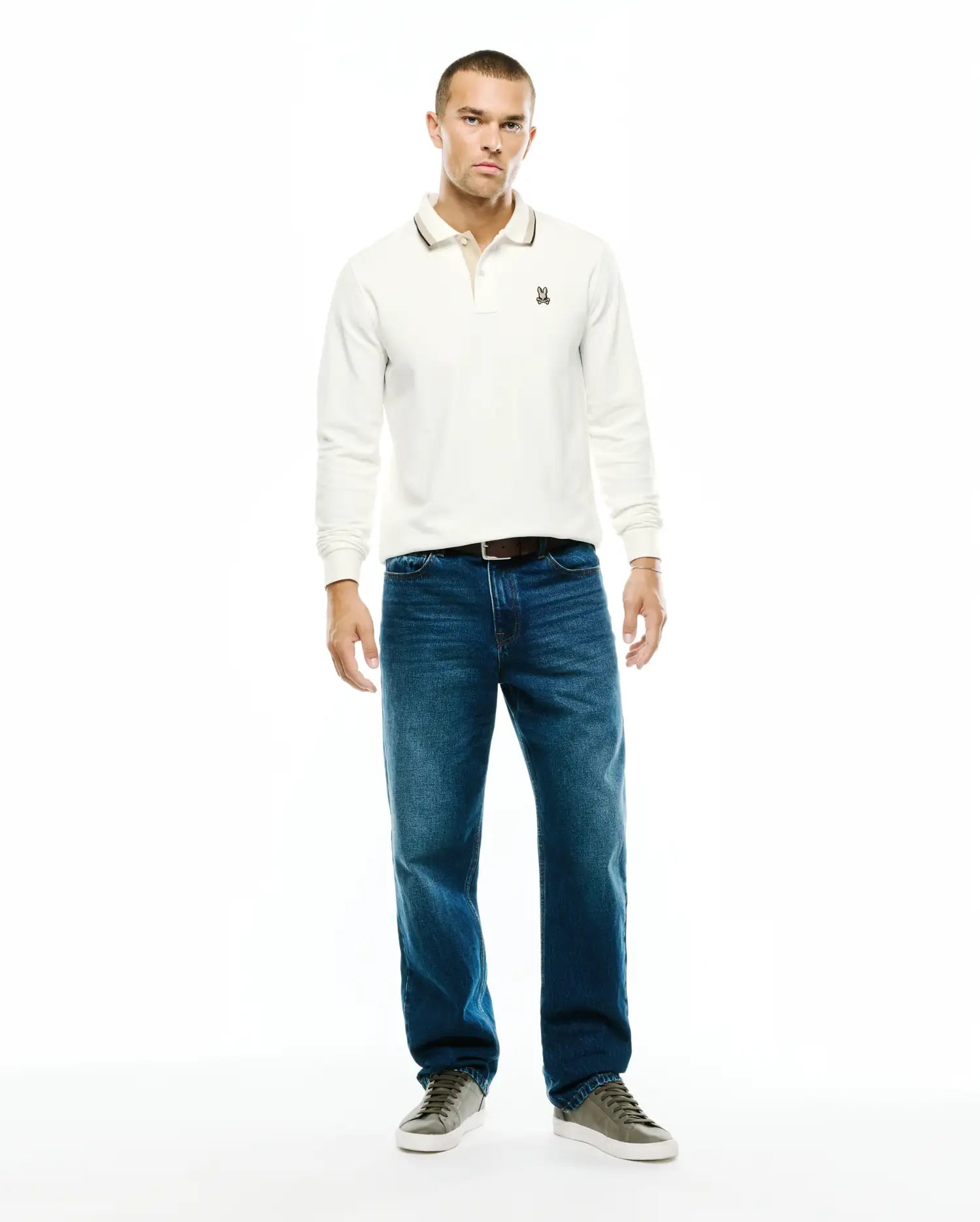 Men's Grover Pique Longsleeve Polo in off-white, classic fit, featuring a textured pique fabric, two-button placket, tipped collar with a dark stripe, and a small embroidered Psycho Bunny skull logo on the left chest. (4)