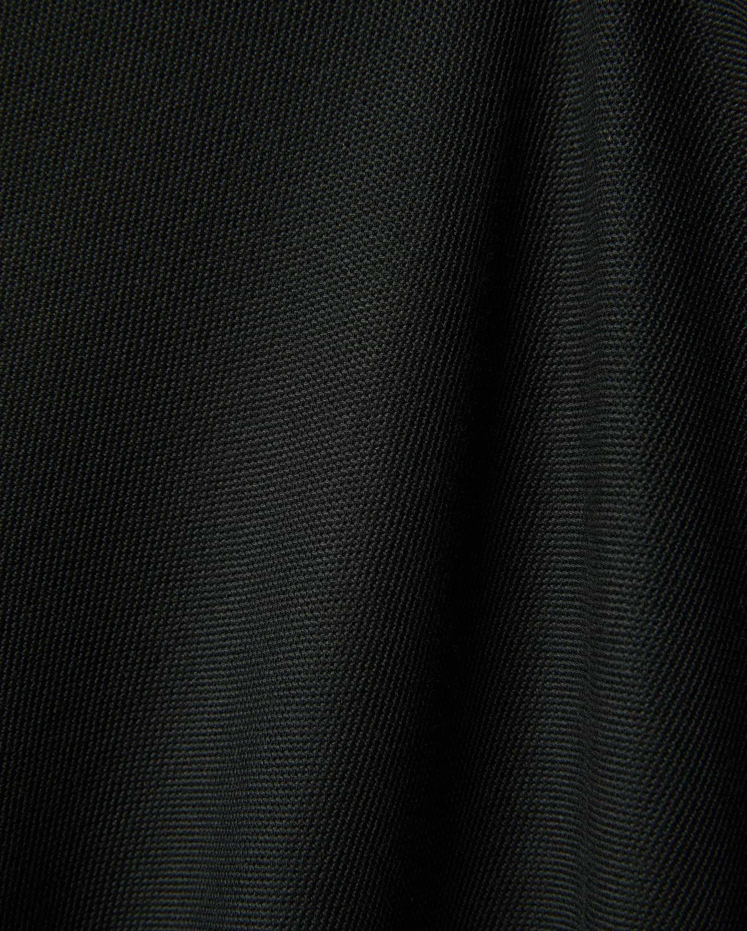 Black Mens Ringston Pique Polo, showcasing its classic pique knit texture, featuring the iconic embroidered Psycho Bunny skull logo on the left chest.