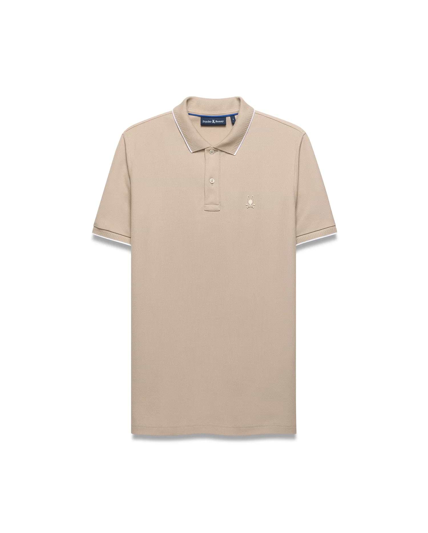 Mens Ringston Pique Polo in beige, featuring a classic fit, textured pique fabric, white tipping on the ribbed collar and cuffs, and a small embroidered Psycho Bunny skull logo on the left chest.