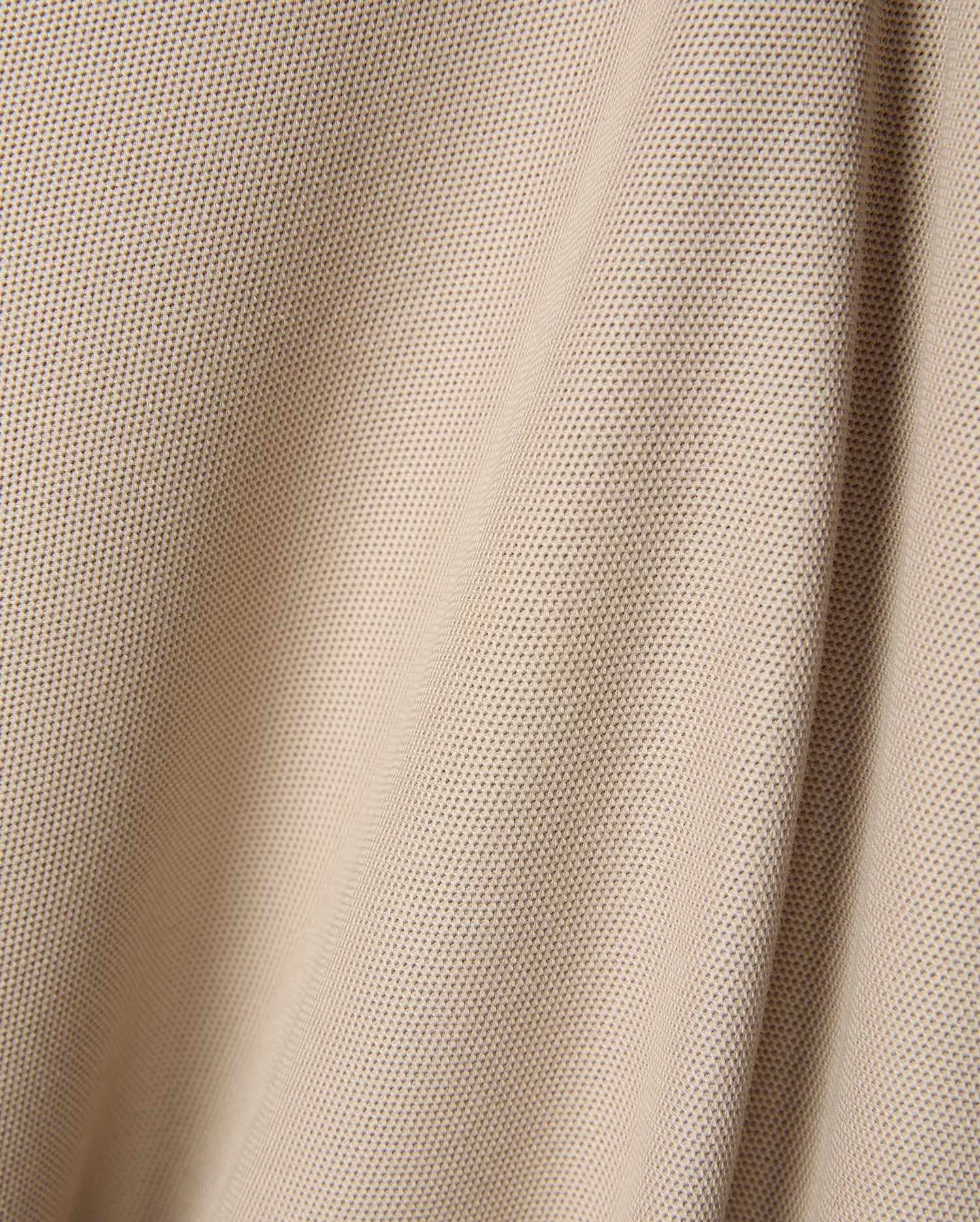 Premium beige Mens Ringston Pique Polo, showcasing a refined textured pique knit fabric, designed for a classic fit, with the iconic embroidered Psycho Bunny skull logo on the chest.
