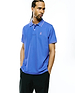 Mens Atley Pique Polo in vibrant royal blue, featuring a classic fit, pique knit fabric, white tipped collar and cuffs, and a small embroidered magenta Psycho Bunny skull logo on the left chest.