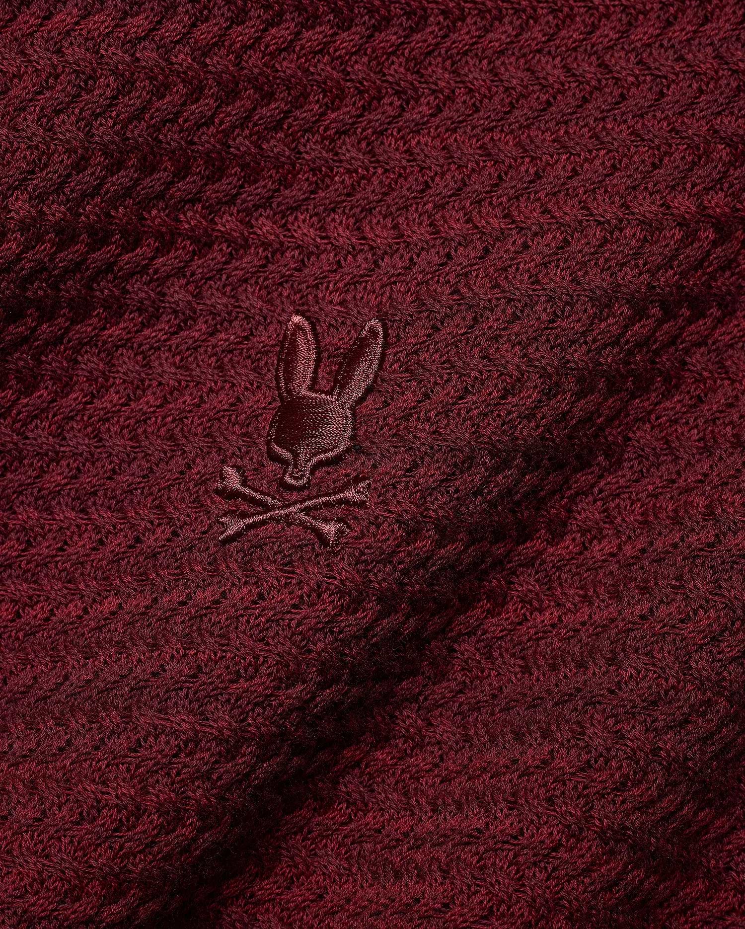 Men's Devon Braided Knit Polo in deep burgundy, featuring a rich braided knit texture and a small, tonal embroidered Psycho Bunny skull logo on the chest. (6)