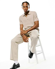 Mens Devon Braided Stitch Knit Polo in a classic fit beige braided knit texture, featuring a small embroidered Psycho Bunny skull logo on the left chest.