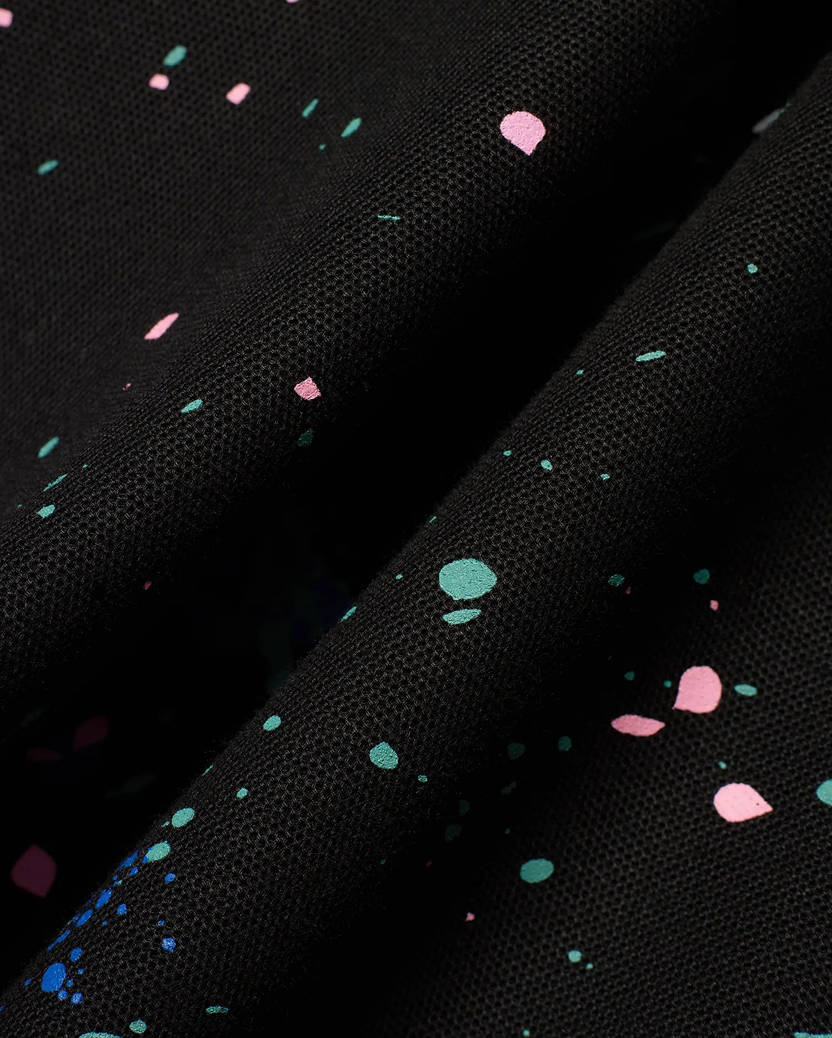 Mens Malcolm Splatter Polo, a premium black pique knit polo featuring a dynamic, all-over paint splatter print in vibrant pink, teal, and blue, embodying refined streetwear style. (6)