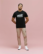 A man with short hair stands against a pink background in a Psycho Bunny MENS ARCHIVE GRADIENT BUNNY GRAPHIC TEE (MT0200029), beige cargo pants, and white high-top sneakers. He has a neutral expression and his hands are in his pockets.