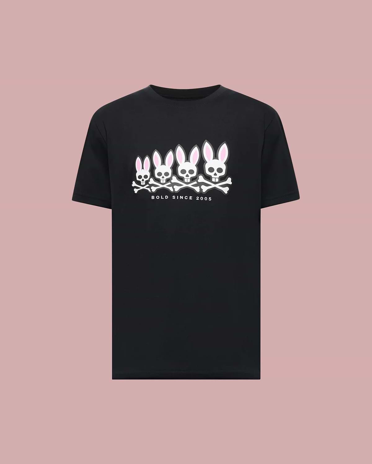 The Psycho Bunny MENS ARCHIVE GRADIANT BUNNY GRAPHIC TEE (MT0200029) is a black tee featuring four iconic Bunny skull and crossbones with pink ears above "BOLD SINCE 2005," set against a plain pink background.