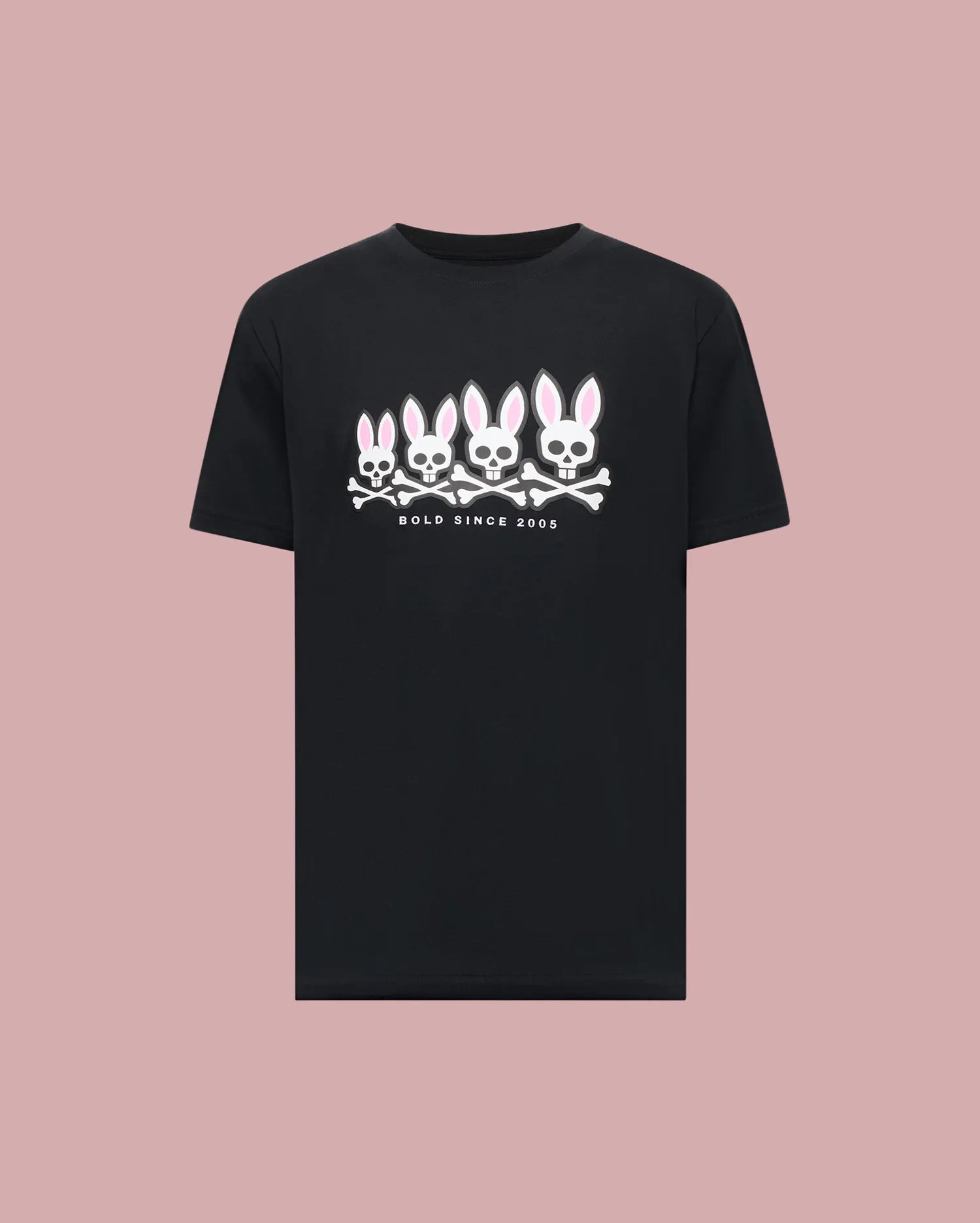 The Psycho Bunny MENS ARCHIVE GRADIANT BUNNY GRAPHIC TEE (MT0200029) is a black tee featuring four iconic Bunny skull and crossbones with pink ears above "BOLD SINCE 2005," set against a plain pink background.