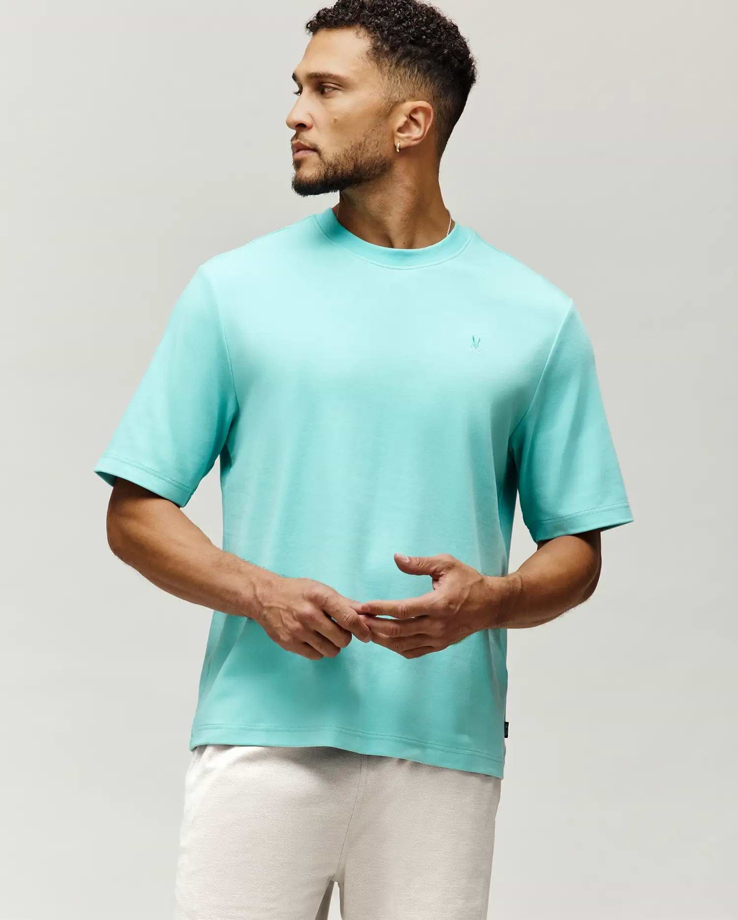 Mens Adam Interlock Tee in vibrant aqua, featuring a relaxed fit, smooth interlock knit, and a small tonal embroidered Psycho Bunny skull logo on the left chest.