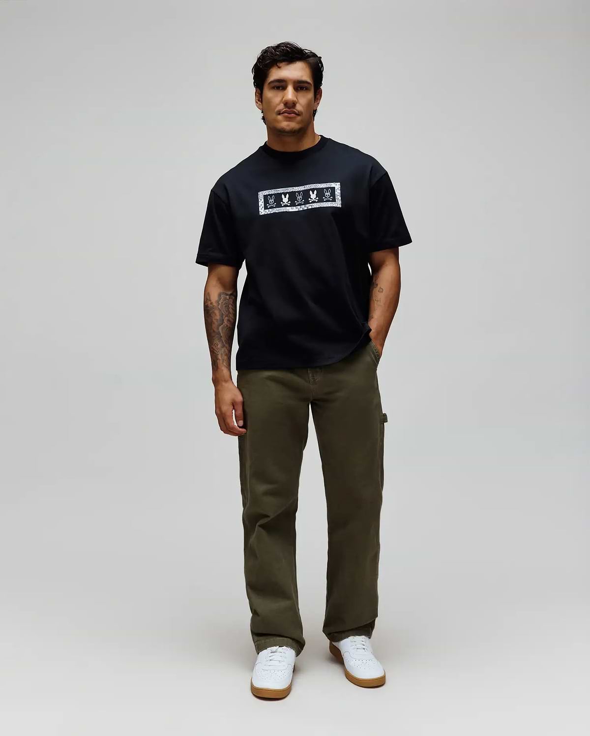 Mens Olivier Oversized Tee in black jersey, featuring a bold white rectangular chest graphic with an intricate bandana-style border and repeated Psycho Bunny skull logos.