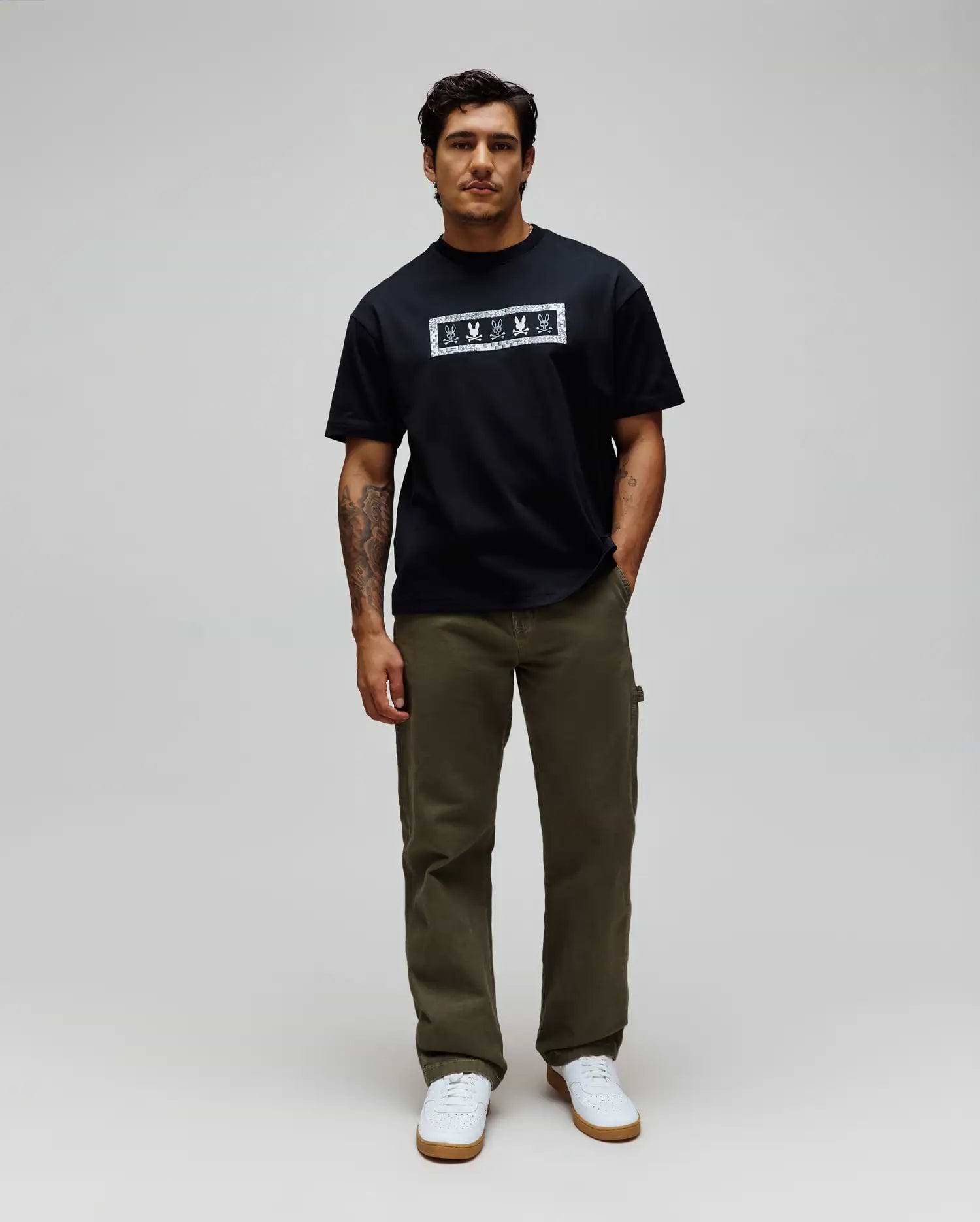 Mens Olivier Oversized Tee in black jersey, featuring a bold white rectangular chest graphic with an intricate bandana-style border and repeated Psycho Bunny skull logos.