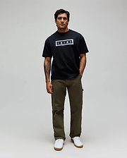 Mens Olivier Oversized Tee in black jersey, featuring a bold white rectangular chest graphic with an intricate bandana-style border and repeated Psycho Bunny skull logos.