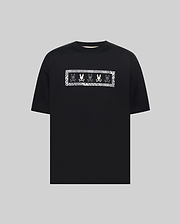 MENS OLIVIER OVERSIZED TEE, a black jersey t-shirt featuring a large white embroidered Psycho Bunny skull logo graphic on the chest, framed by a subtle checkered pattern.