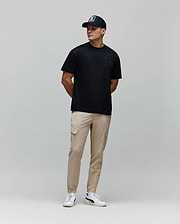 Mens Oscar Oversized Tee, a black smooth jersey t-shirt featuring a relaxed fit and a small, tonal embroidered Psycho Bunny skull logo on the left chest.