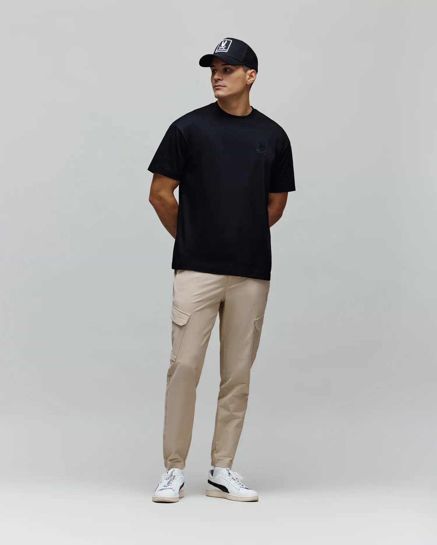 Mens Oscar Oversized Tee, a black smooth jersey t-shirt featuring a relaxed fit and a small, tonal embroidered Psycho Bunny skull logo on the left chest.