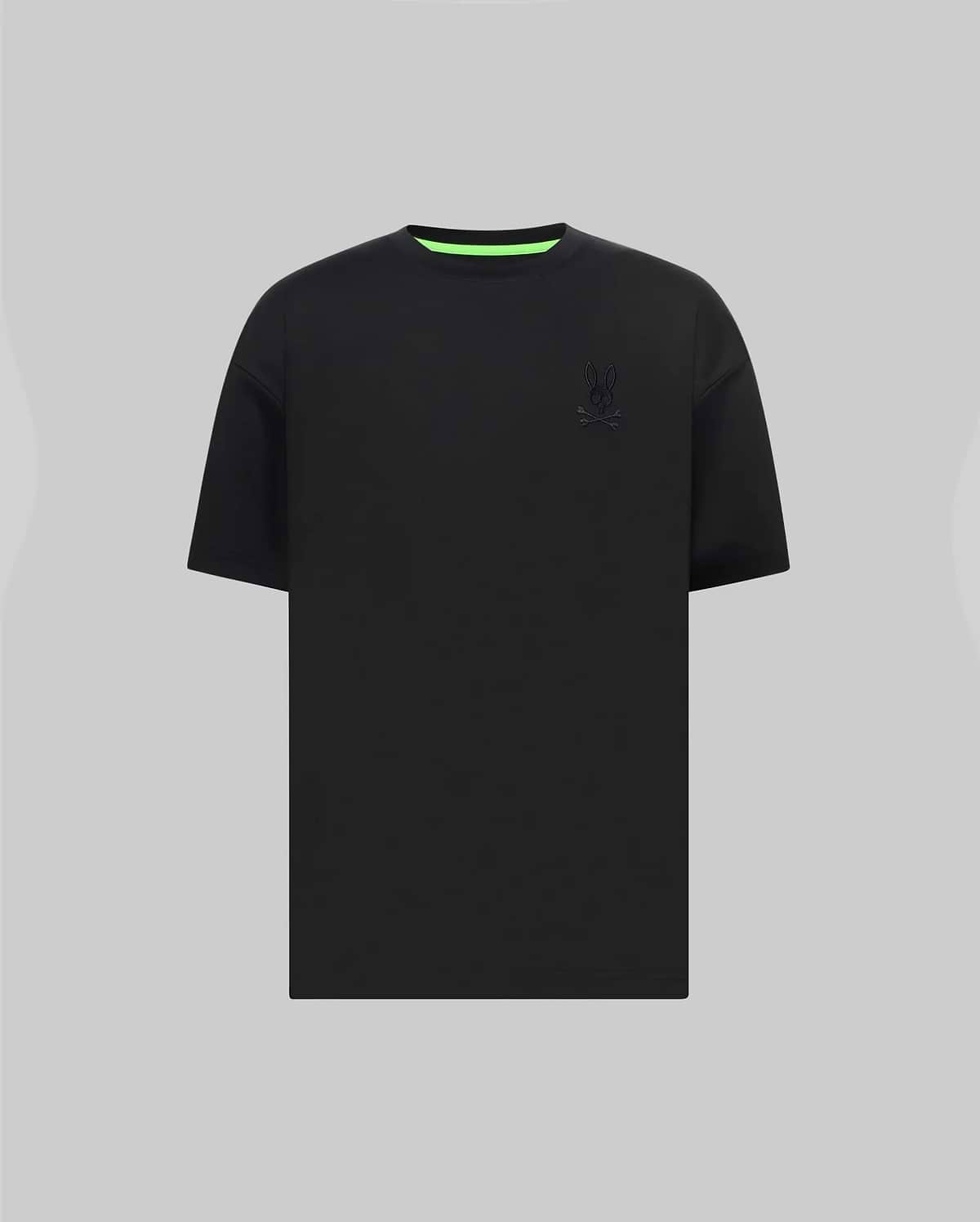 Mens Oscar Oversized Tee in black jersey knit, featuring a relaxed fit, small tonal embroidered Psycho Bunny skull logo on the left chest, and a vibrant neon green inner collar.