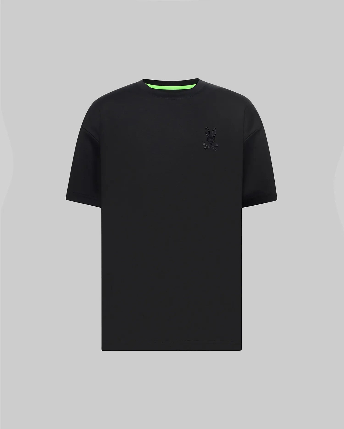 Mens Oscar Oversized Tee in black jersey knit, featuring a relaxed fit, small tonal embroidered Psycho Bunny skull logo on the left chest, and a vibrant neon green inner collar.