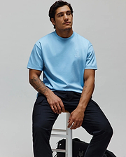 Mens Oscar Oversized Tee in light blue, crafted from smooth jersey knit fabric, featuring a small white embroidered Psycho Bunny skull logo on the left chest for a relaxed fit. (1)