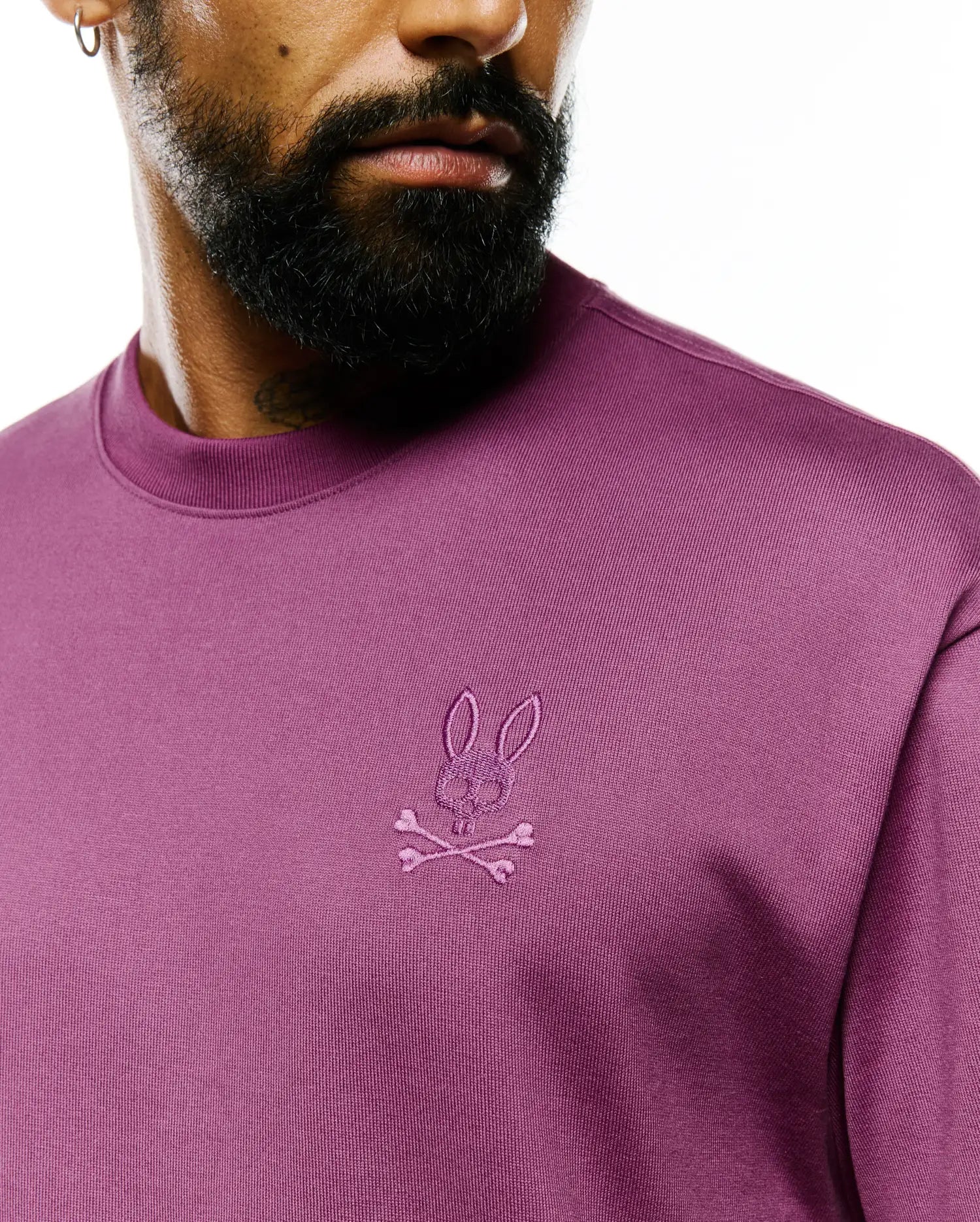 Mens Oscar Relaxed Fit Tee, a premium plum jersey knit t-shirt with a relaxed fit, featuring the iconic small tonal embroidered Psycho Bunny skull and crossbones logo on the left chest.