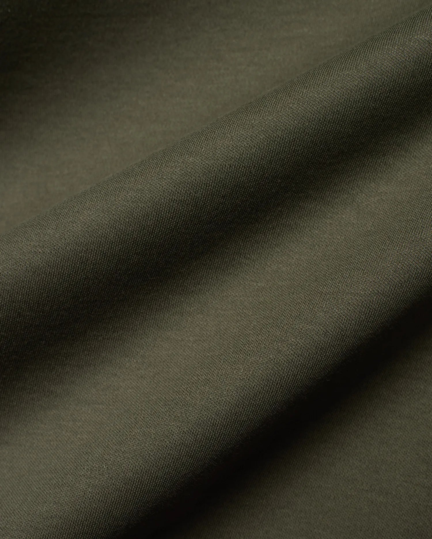 Mens Oscar Relaxed Fit Tee in deep, earthy olive green, showcasing a finely woven, subtly textured pique knit fabric, ideal for premium streetwear comfort.