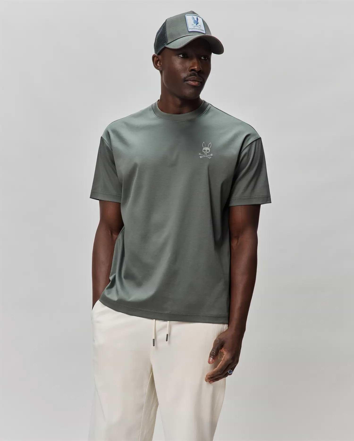 Mens Oscar Oversized Tee in muted sage green, featuring a smooth jersey texture and a small, white embroidered Psycho Bunny skull logo on the left chest. (1)