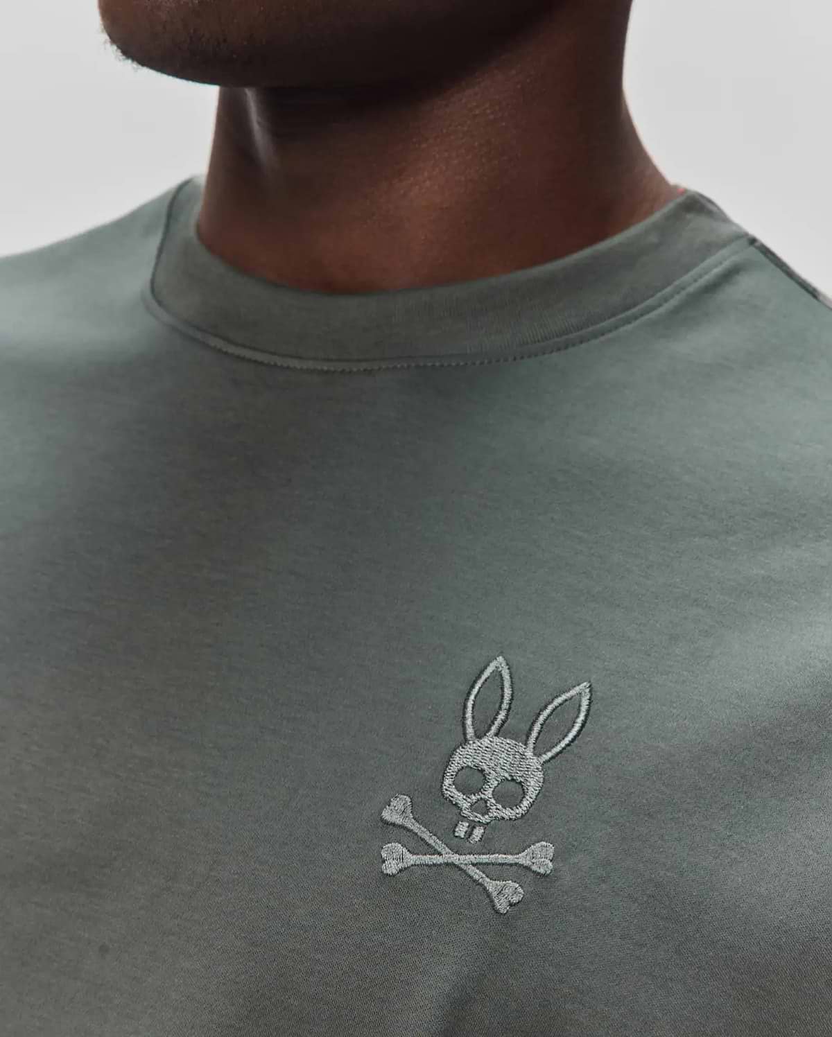 Mens Oscar Oversized Tee in dark olive green jersey knit, featuring a small, embroidered light grey Psycho Bunny skull and crossbones logo on the left chest. (2)