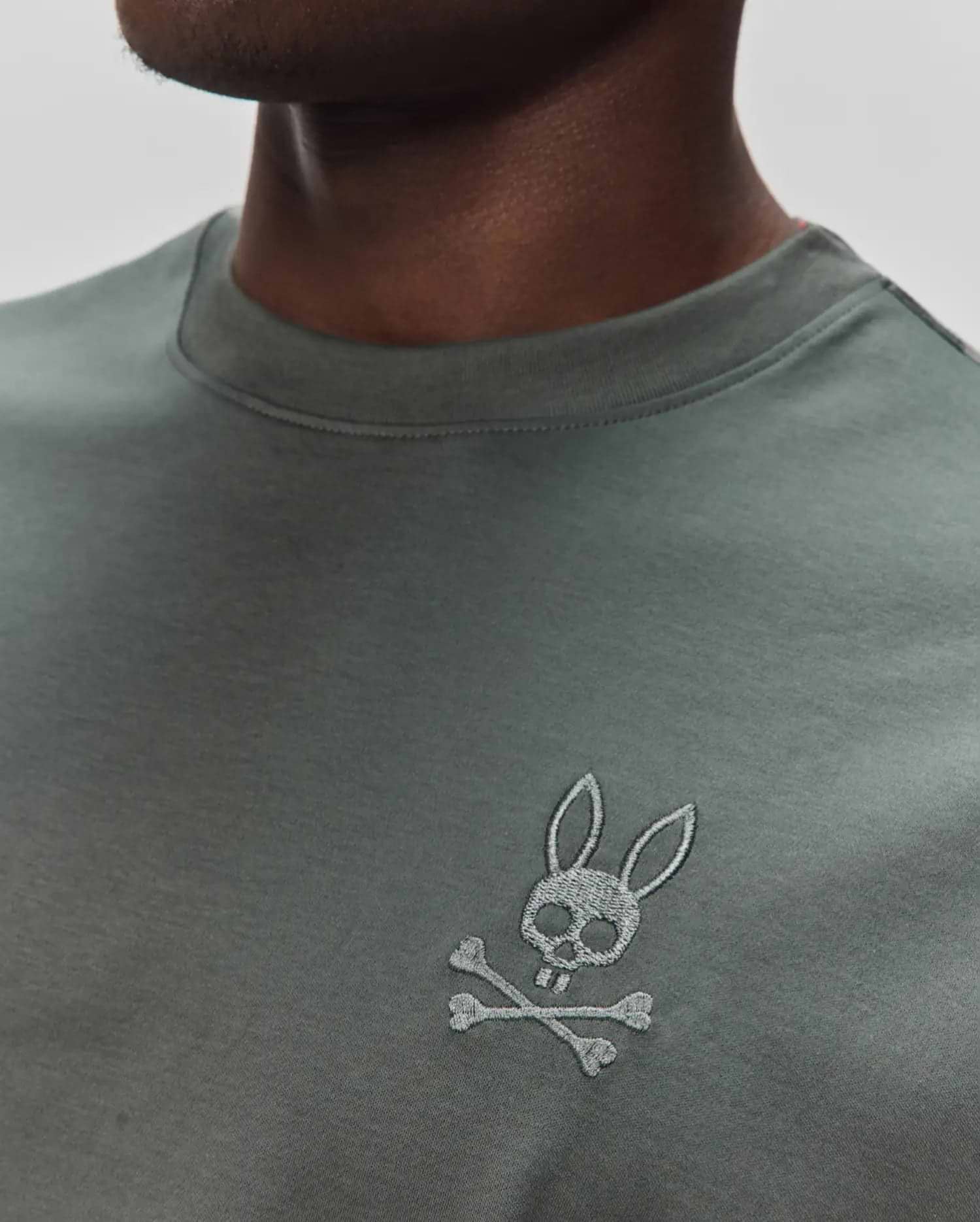 Mens Oscar Oversized Tee in dark olive green jersey knit, featuring a small, embroidered light grey Psycho Bunny skull and crossbones logo on the left chest. (2)