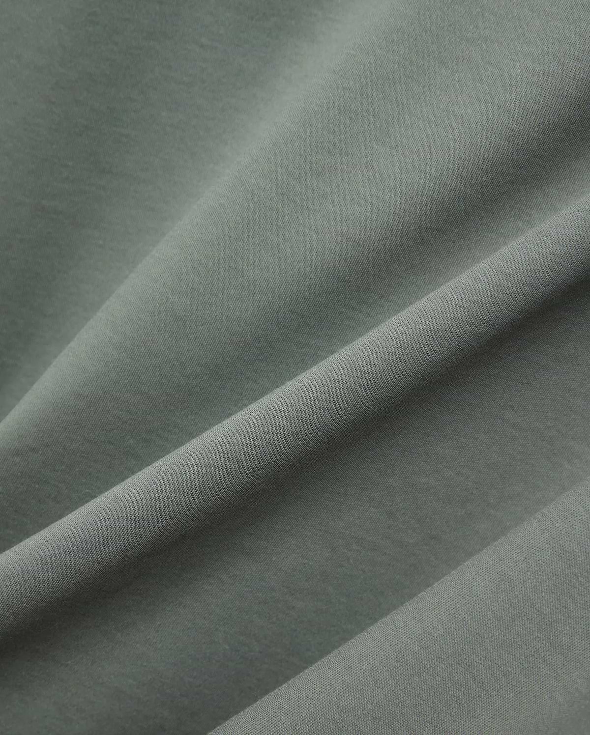 MENS OSCAR OVERSIZED TEE, a premium oversized tee in a rich sage green, featuring a finely textured, soft jersey knit fabric with elegant drapes and subtle sheen. (5)