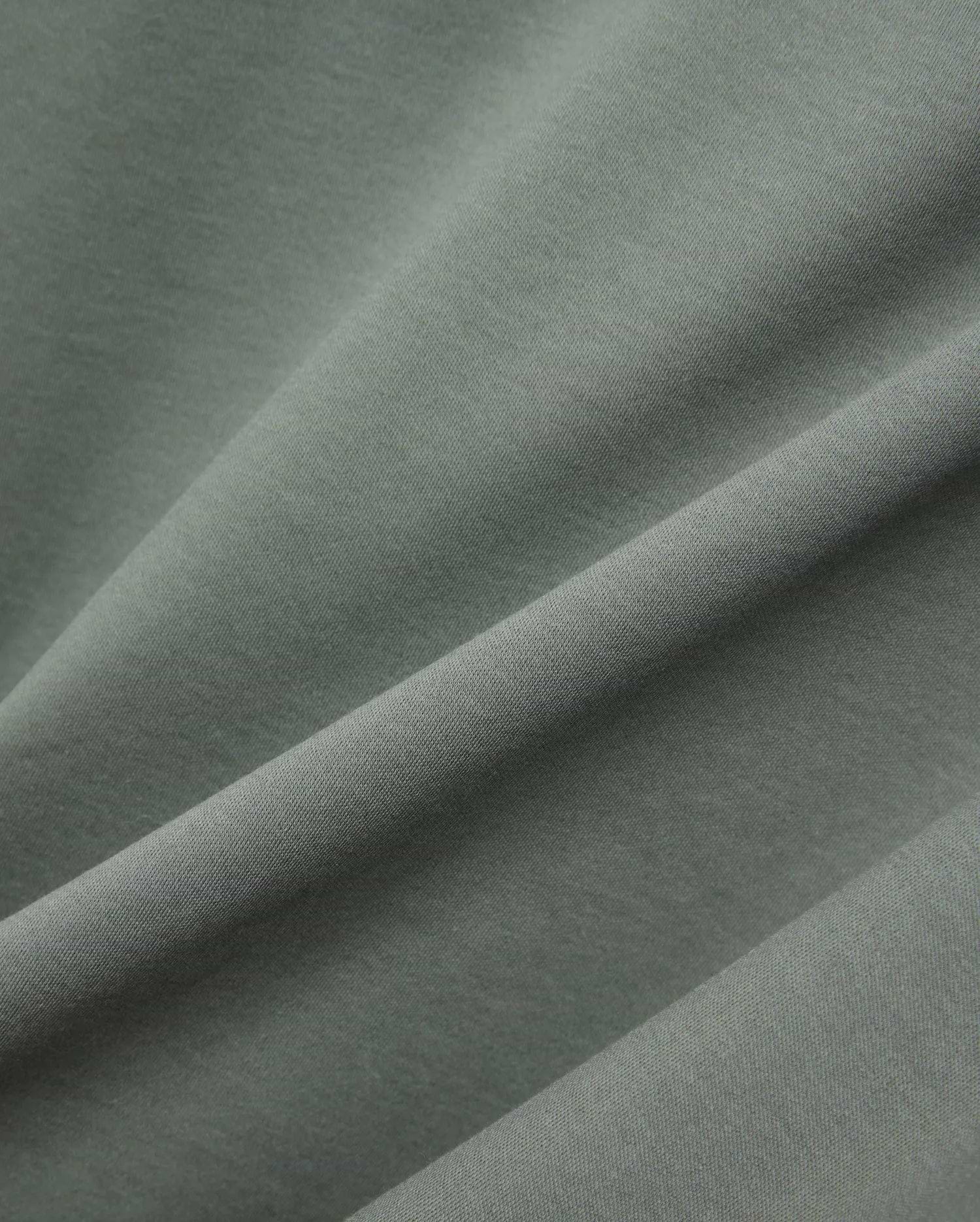 MENS OSCAR OVERSIZED TEE, a premium oversized tee in a rich sage green, featuring a finely textured, soft jersey knit fabric with elegant drapes and subtle sheen. (5)